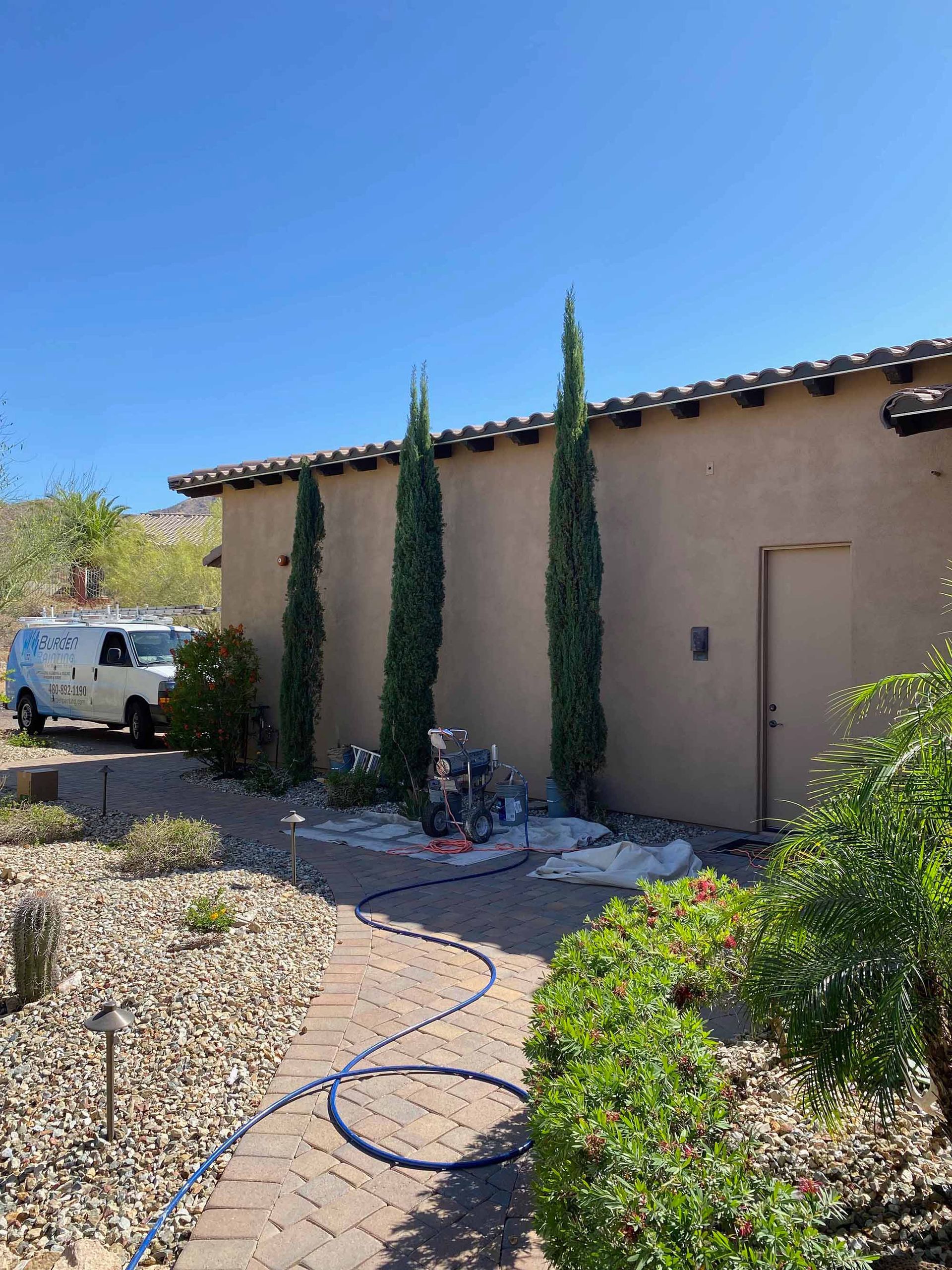 A white van is parked in front of a house.