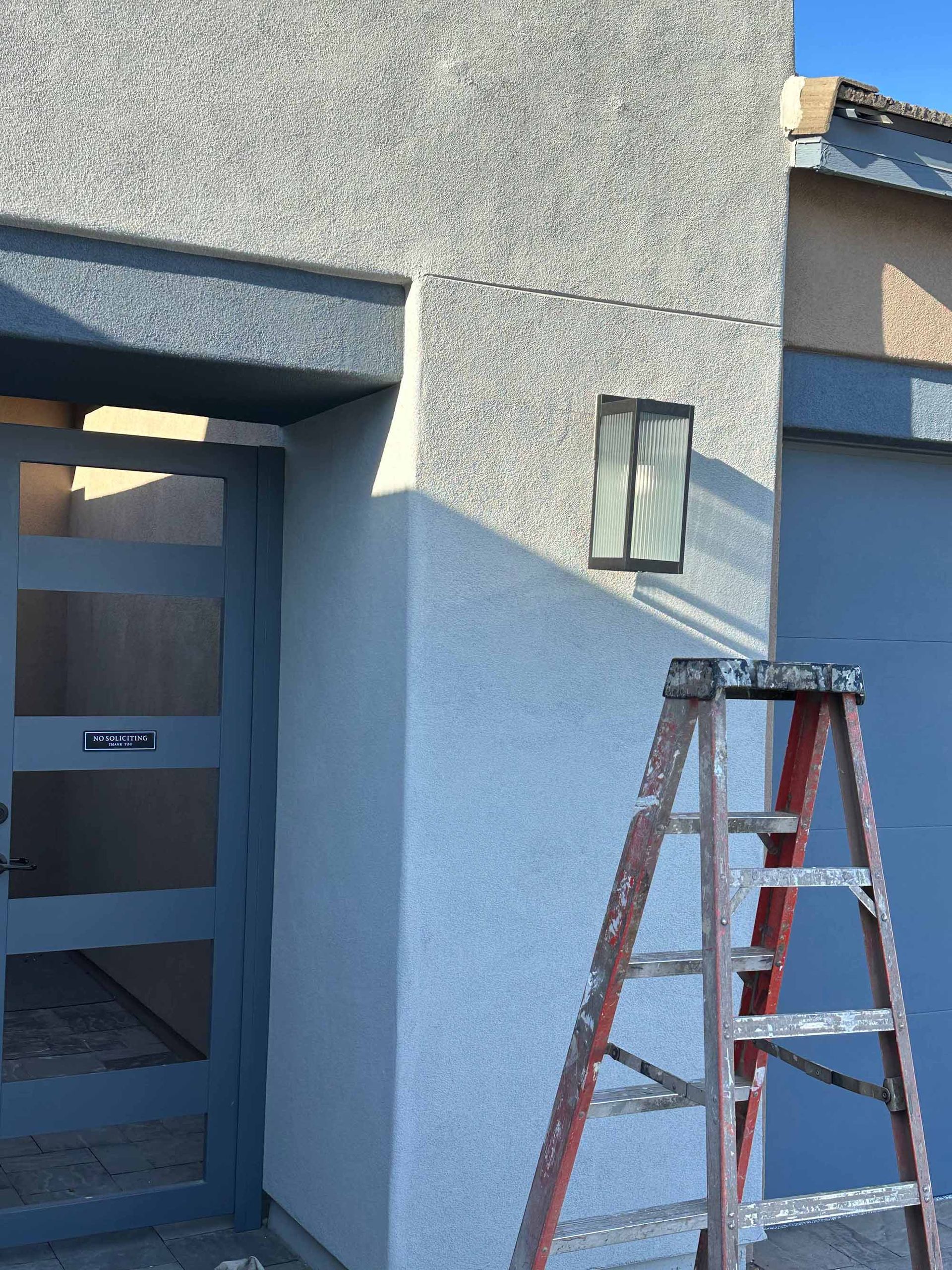 A ladder is leaning against the side of a building