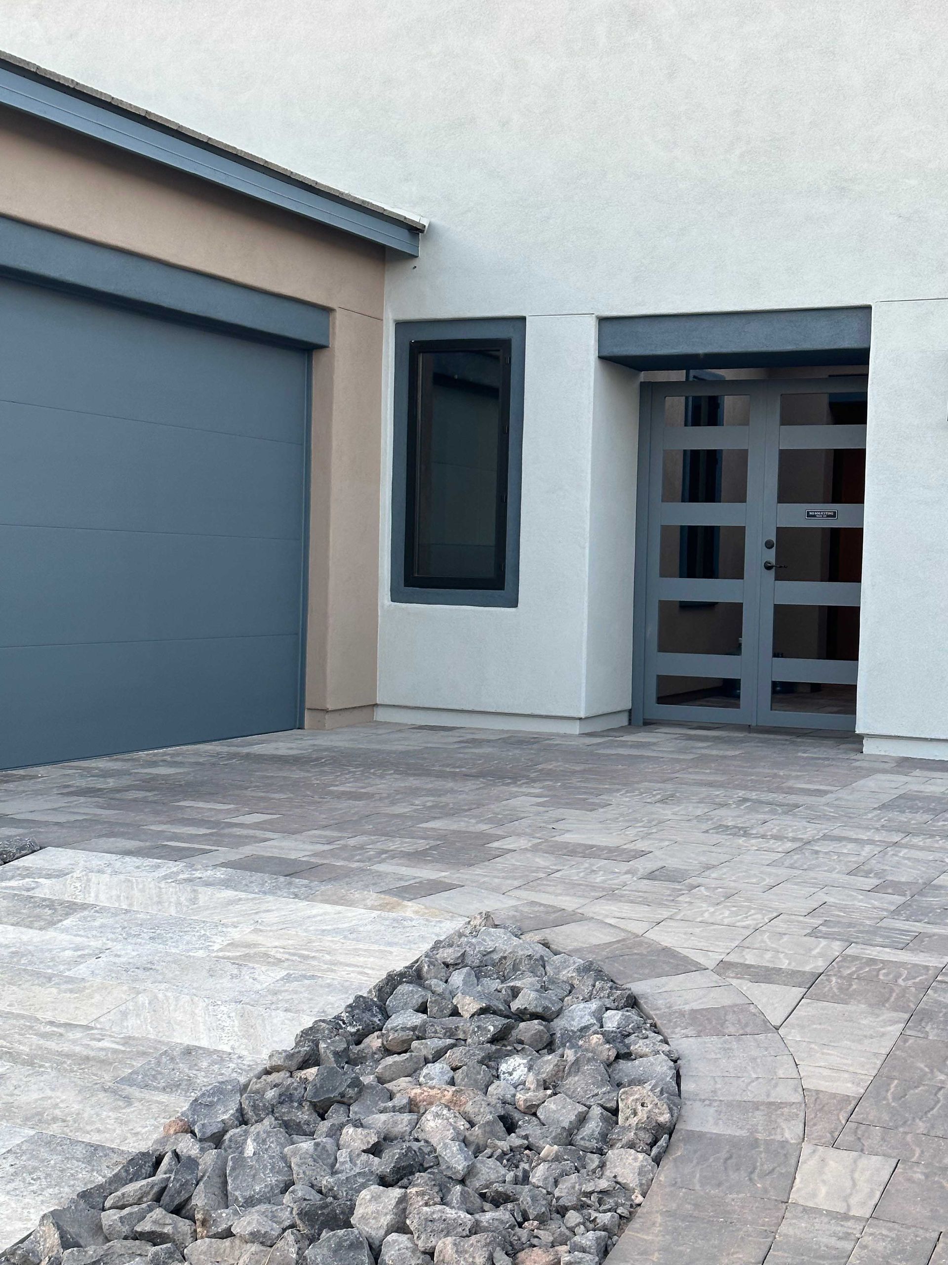 A white house with a blue garage door