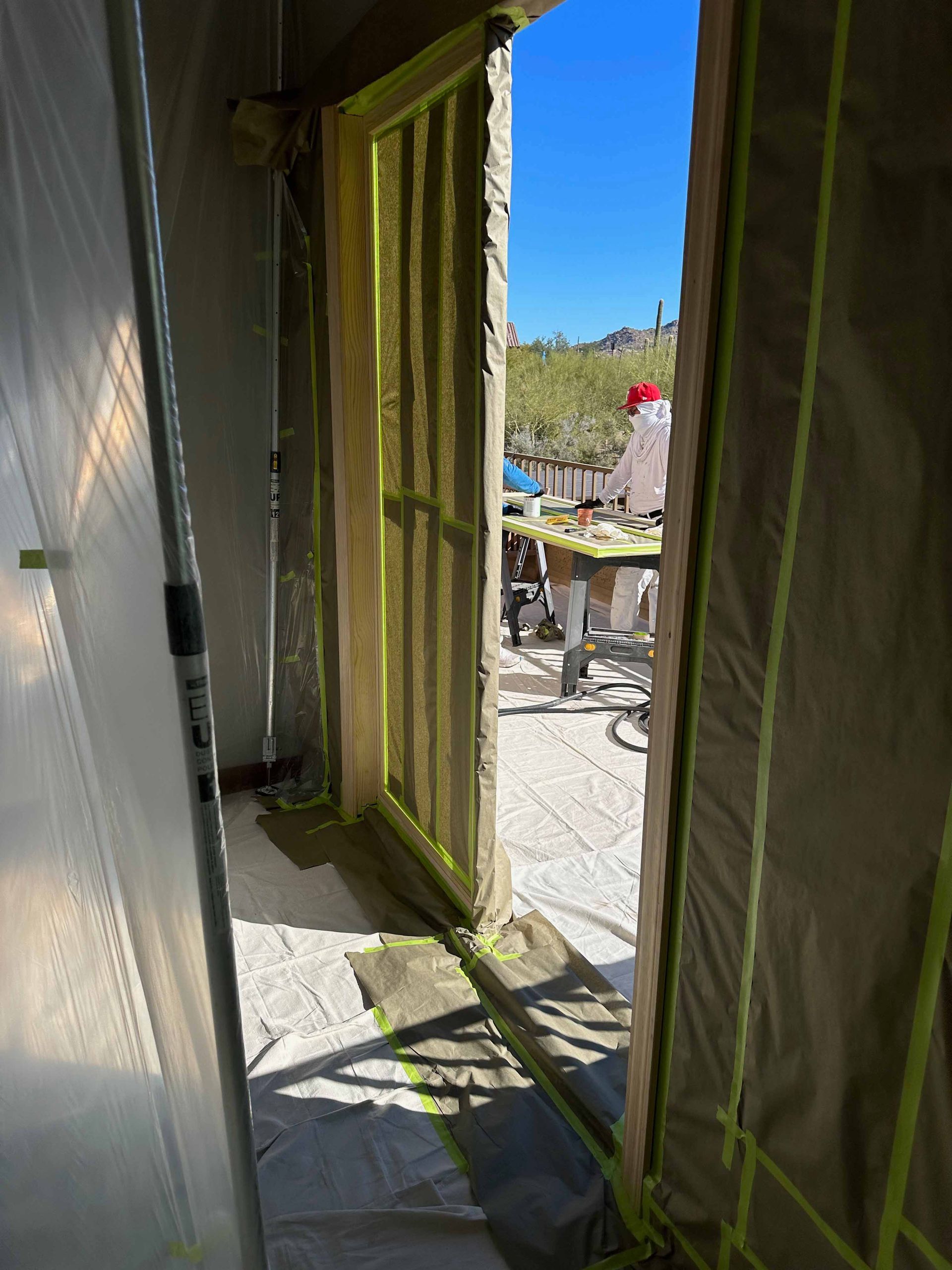A room with a door that is open and covered in plastic.
