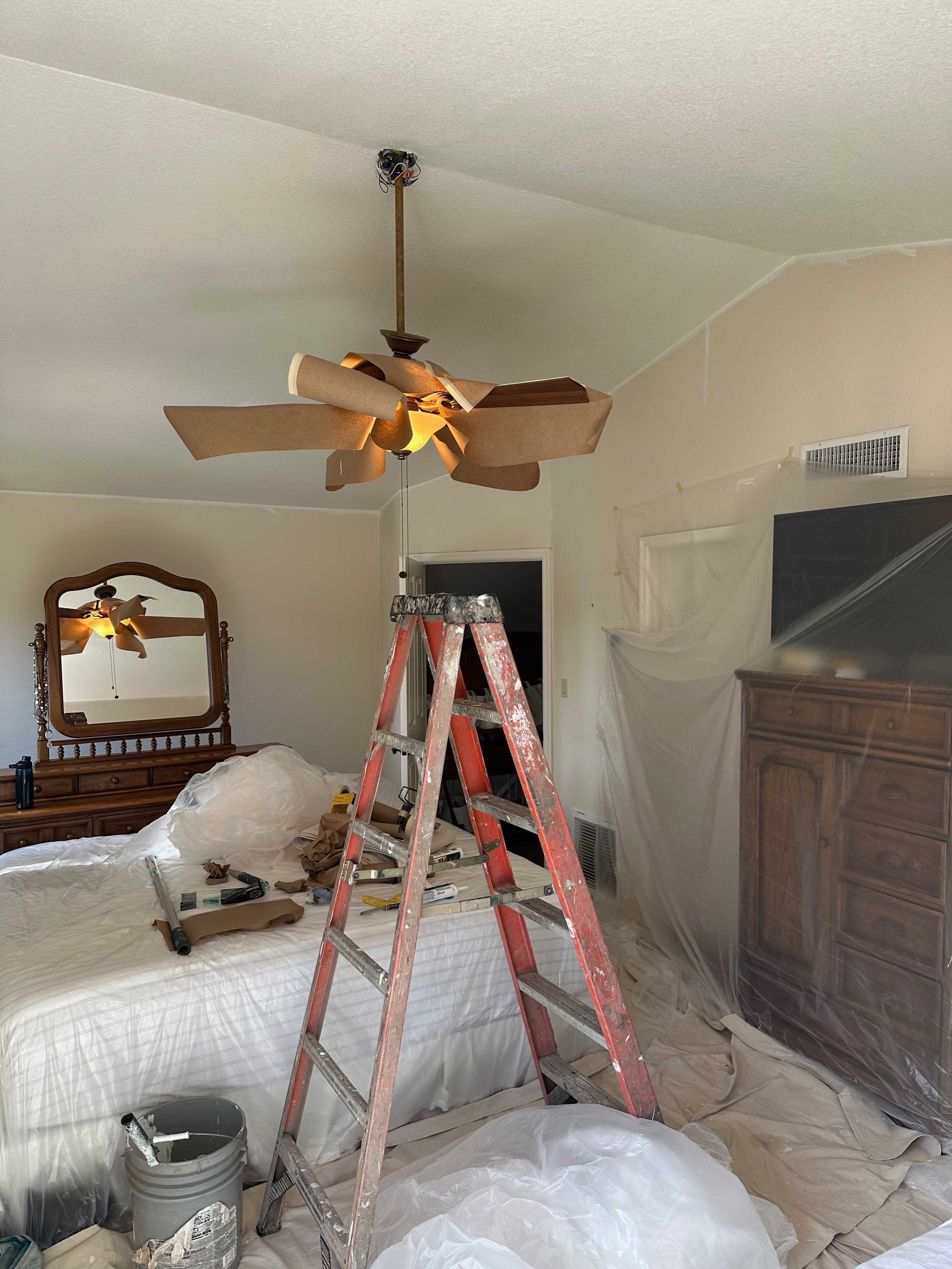A ceiling fan is hanging from the ceiling in a bedroom.