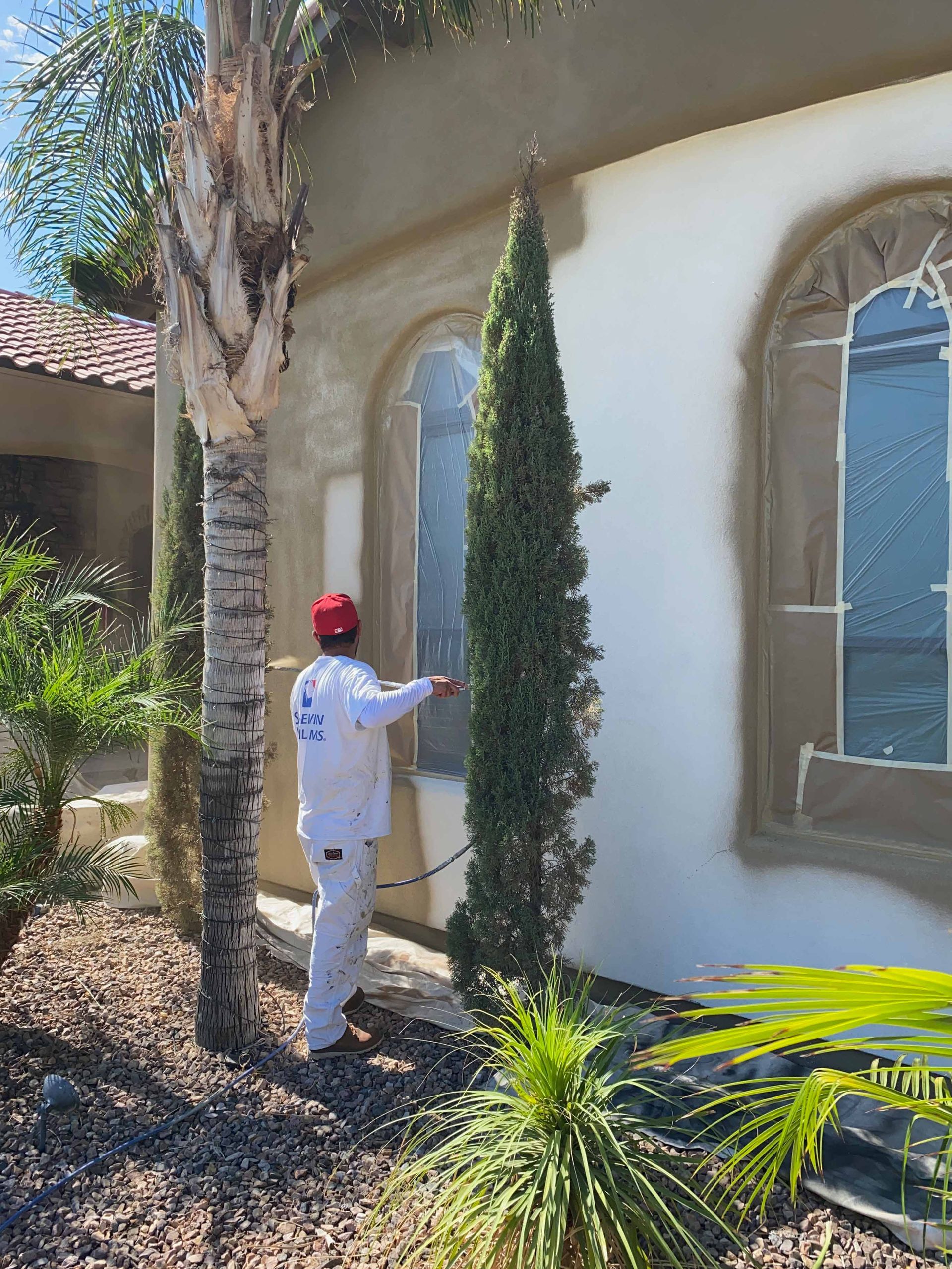 A man is painting the side of a house.