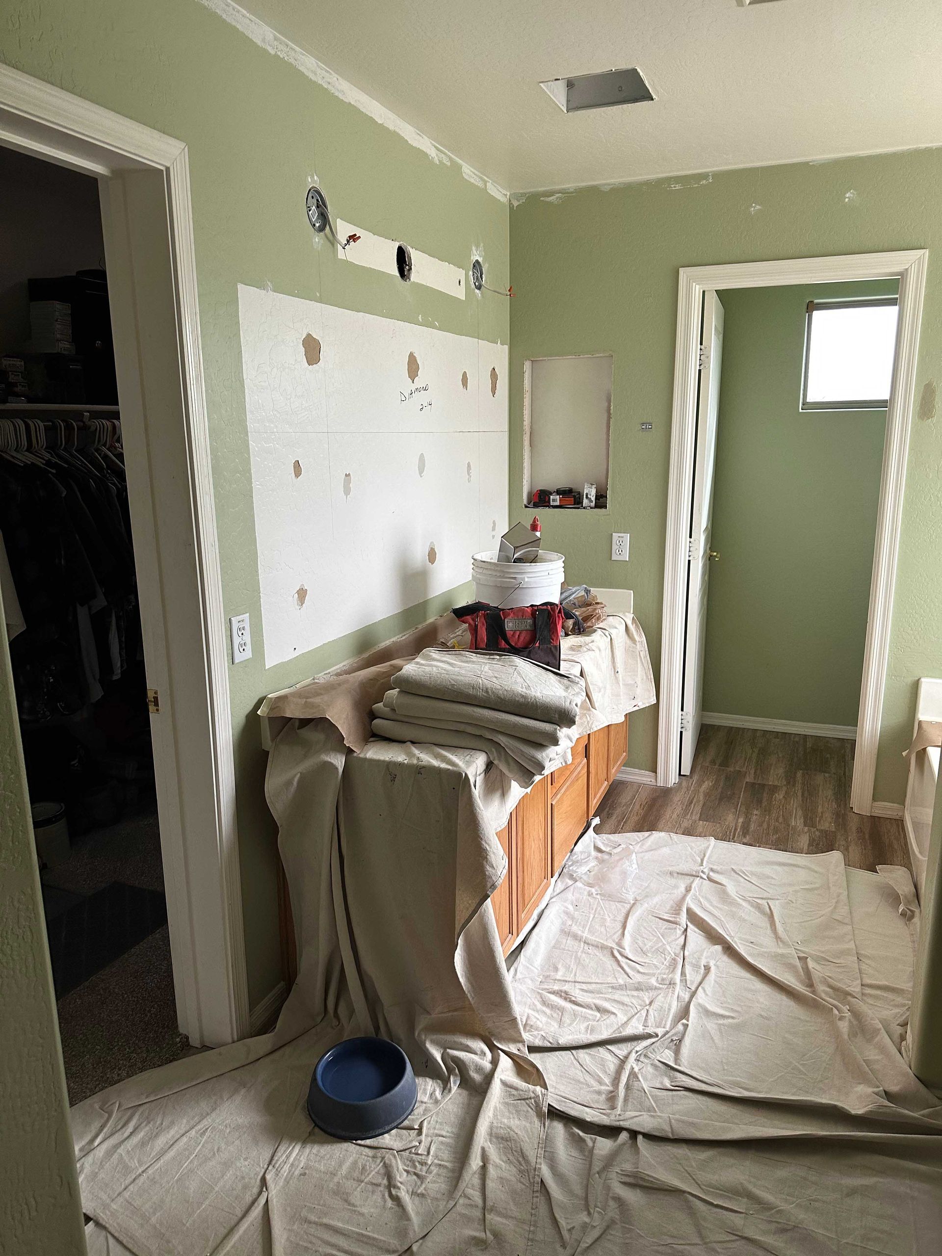 A bathroom is being painted in a house.