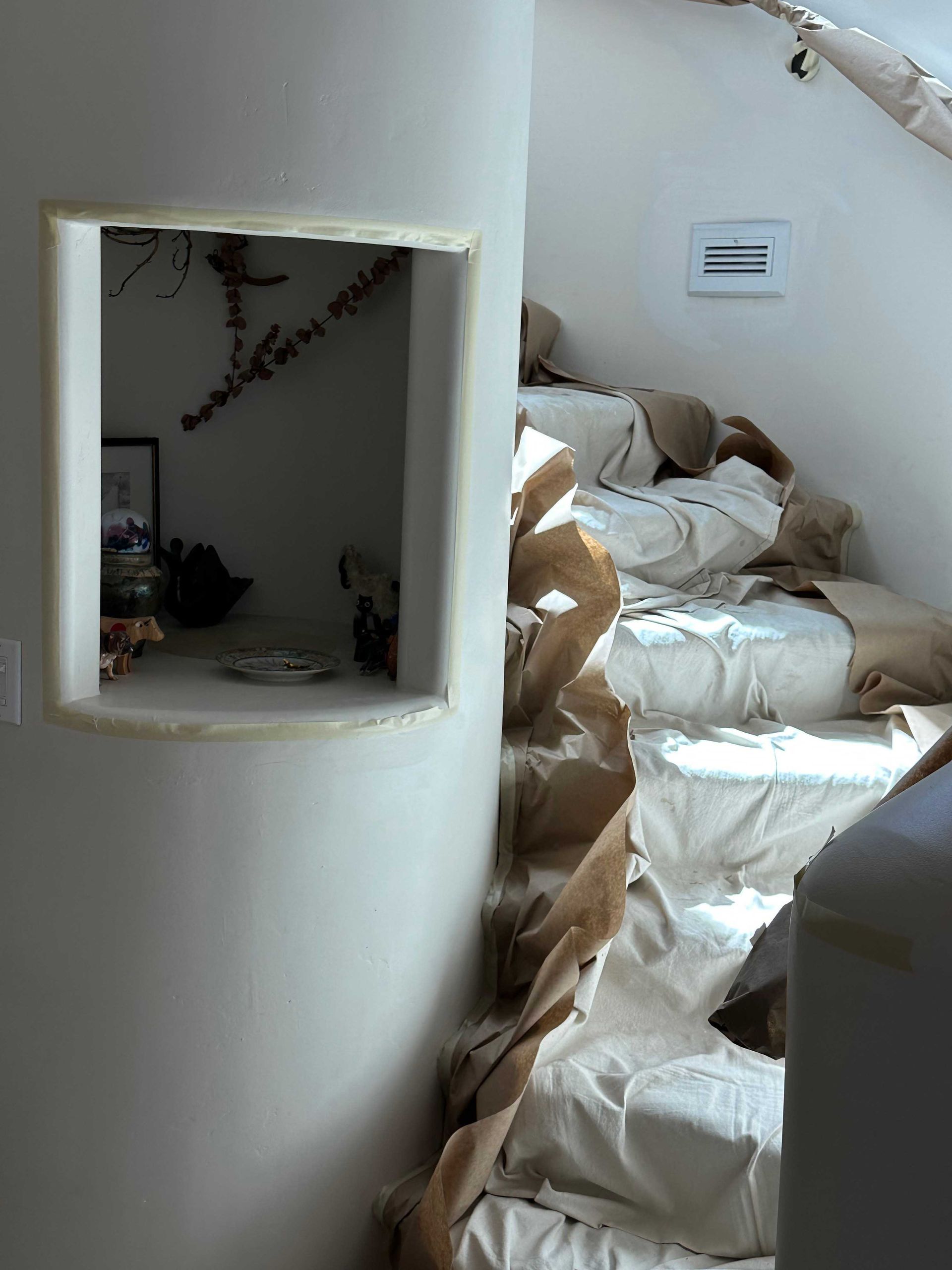 A bedroom with a staircase leading up to a bed