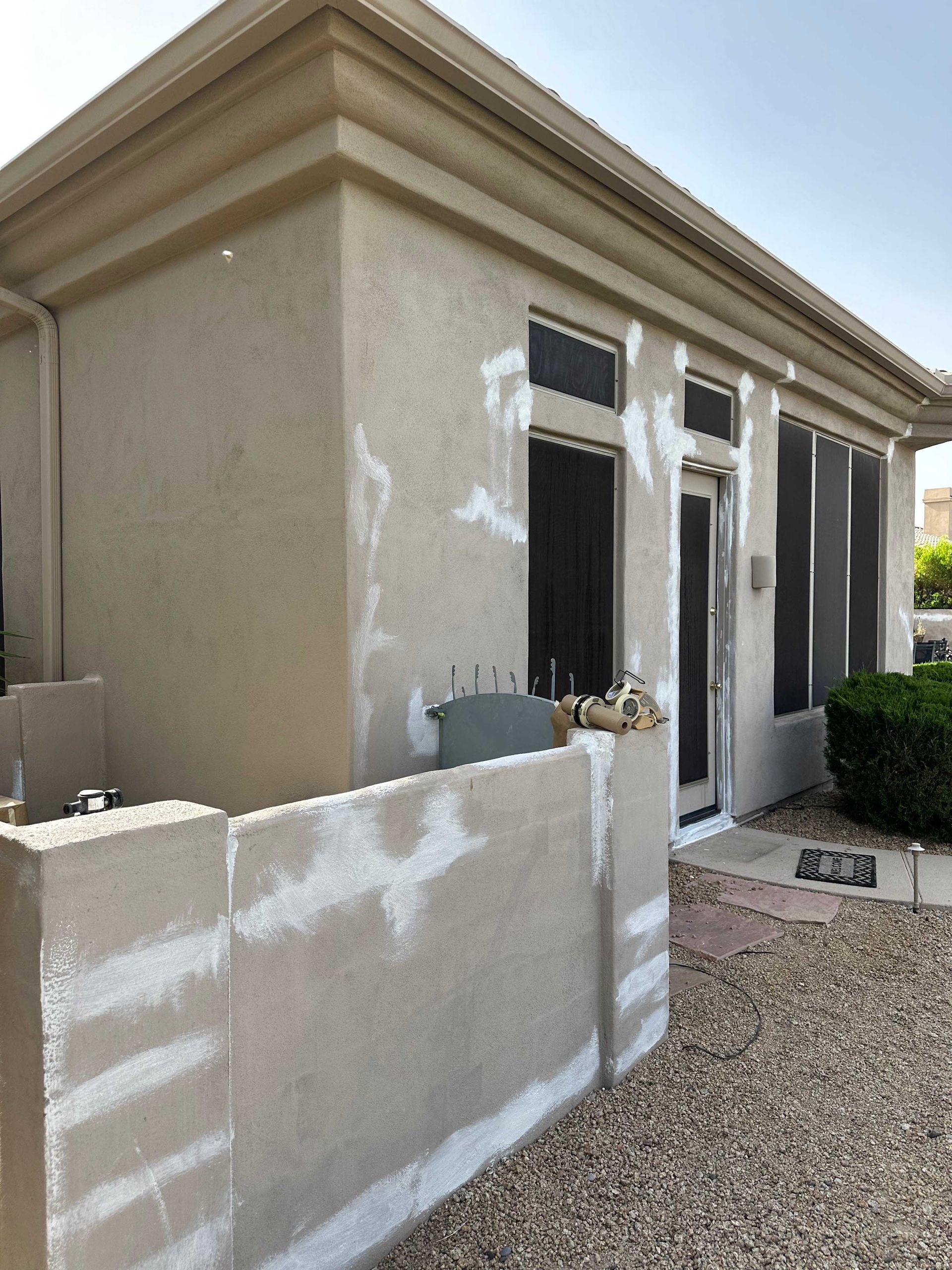 A house with a fence in front of it is being painted.