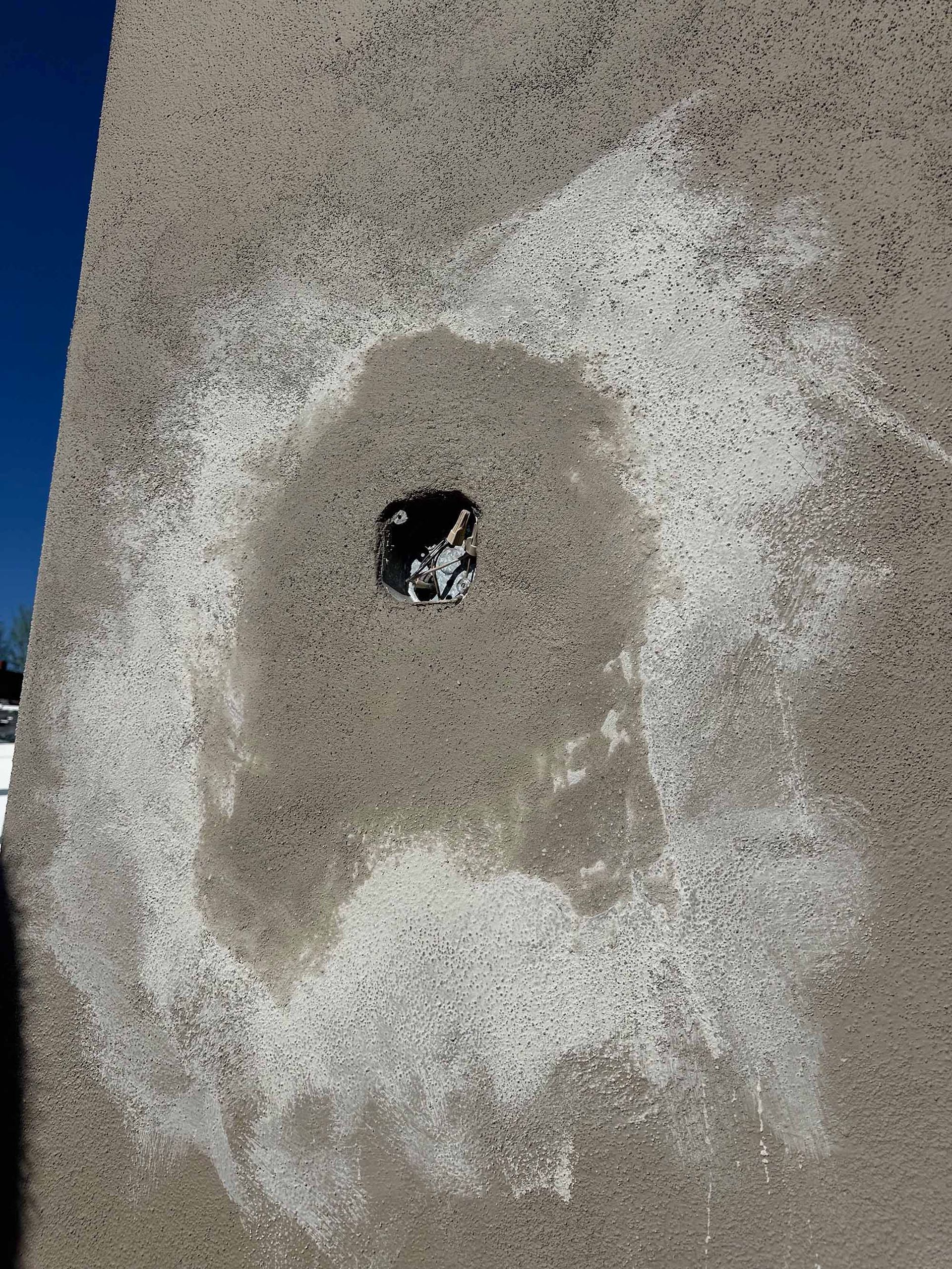 A close up of a hole in a concrete wall.