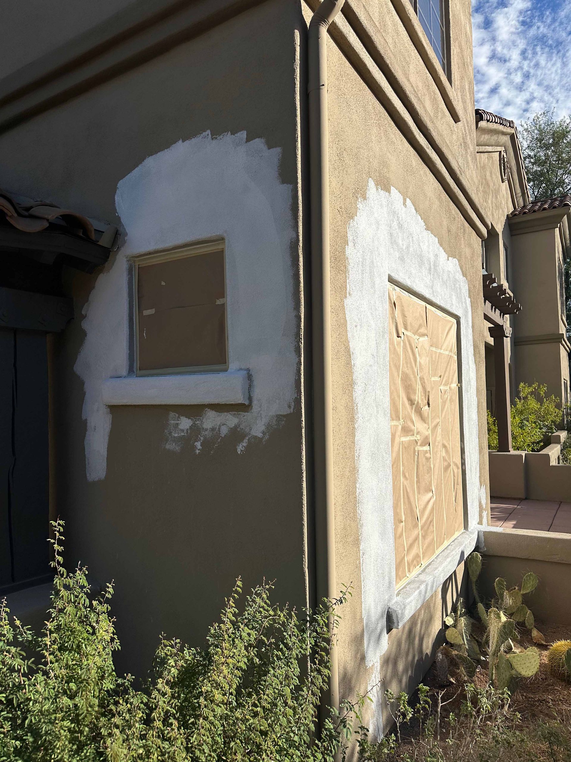 A house with a window boarded up and painted white