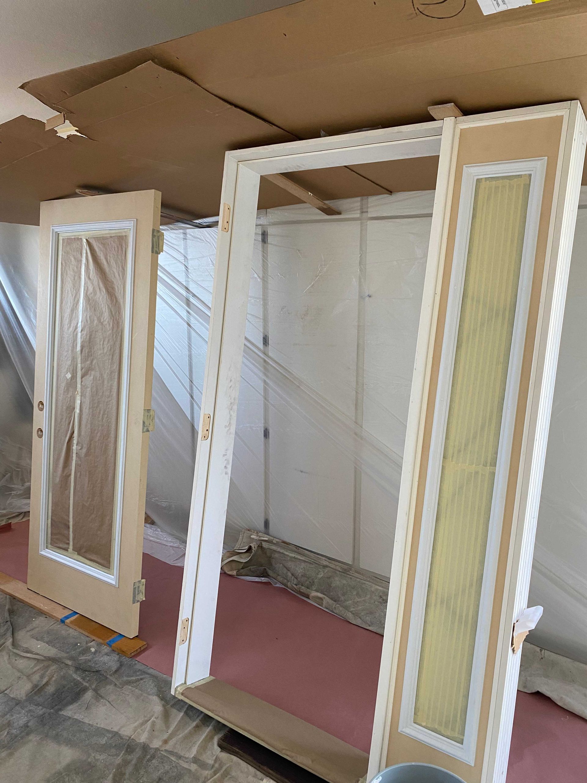 Three doors are sitting on top of each other in a room