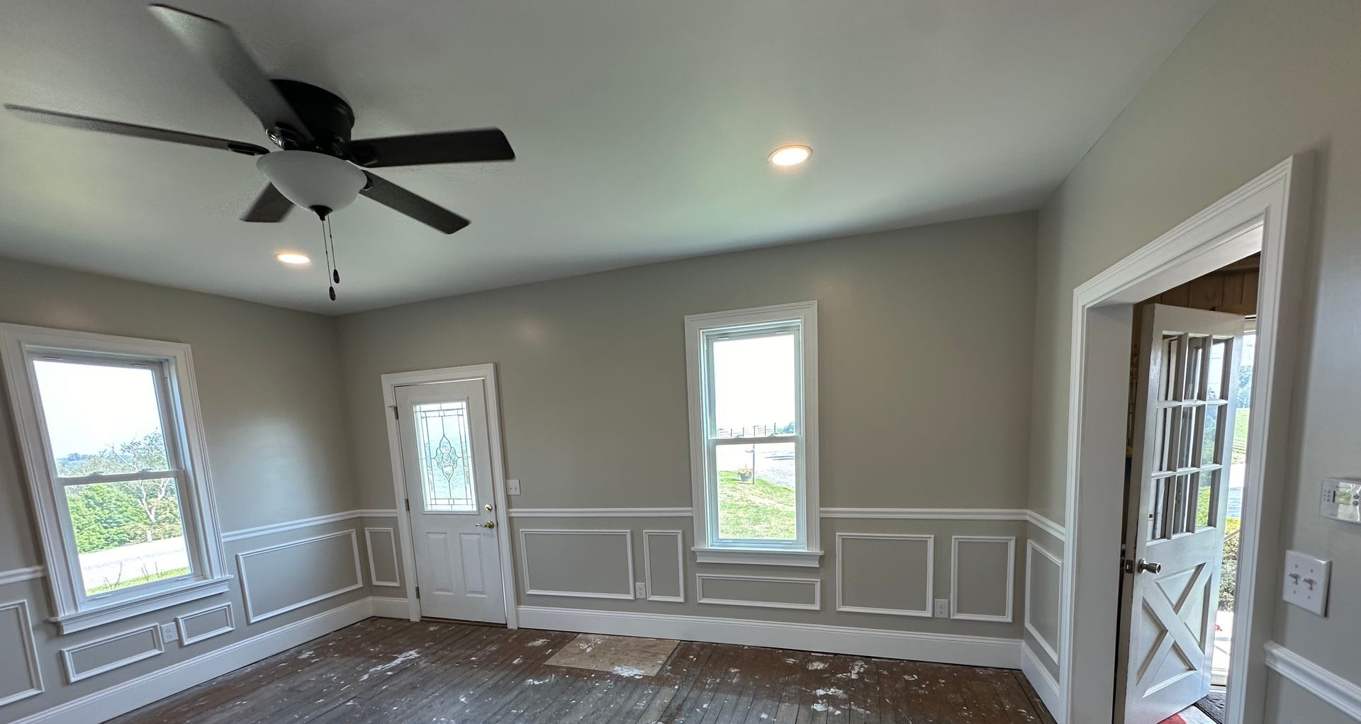 A living room with a fireplace , couch, and chandelier.