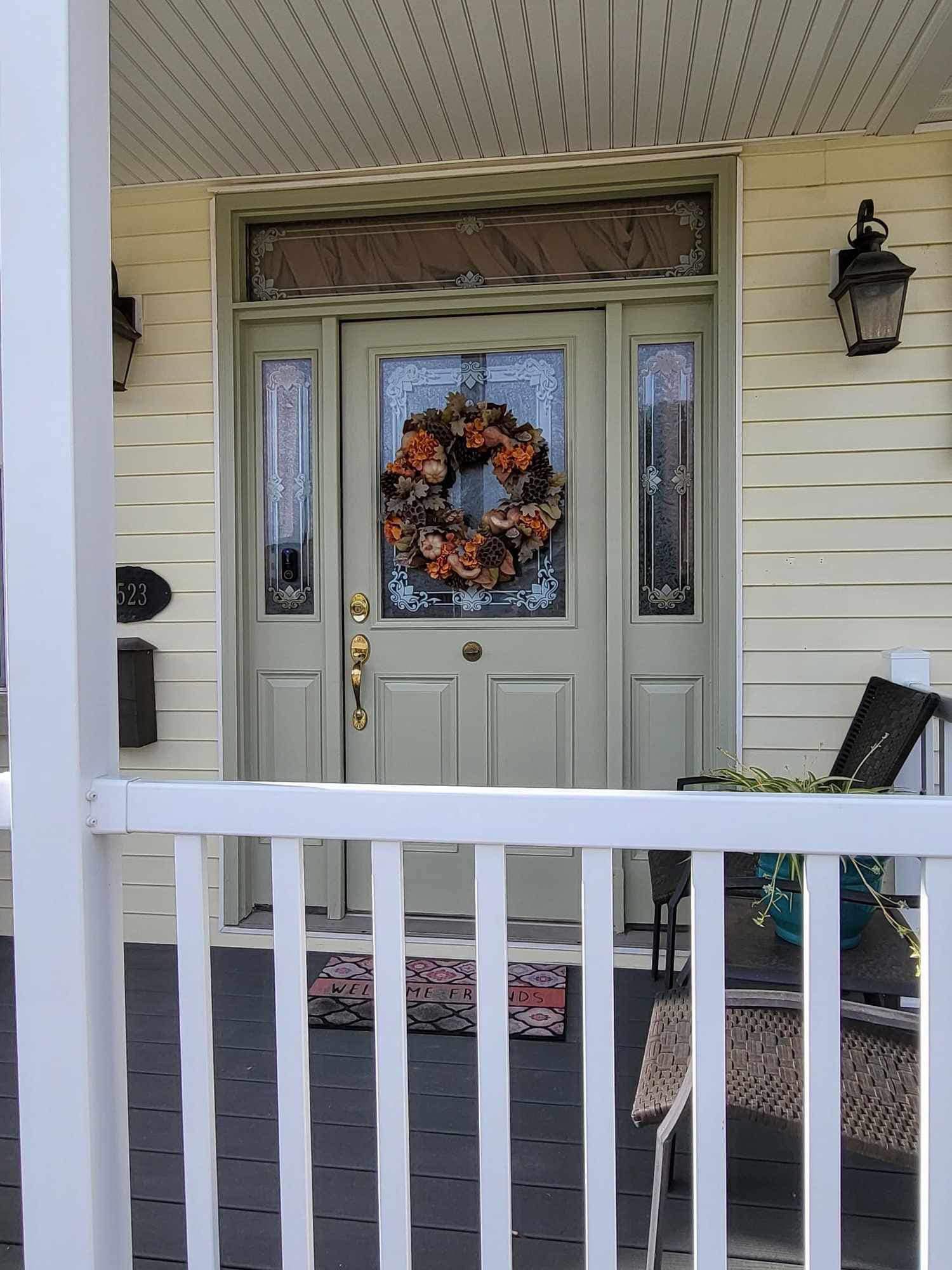 The front door of a house with a wreath on it