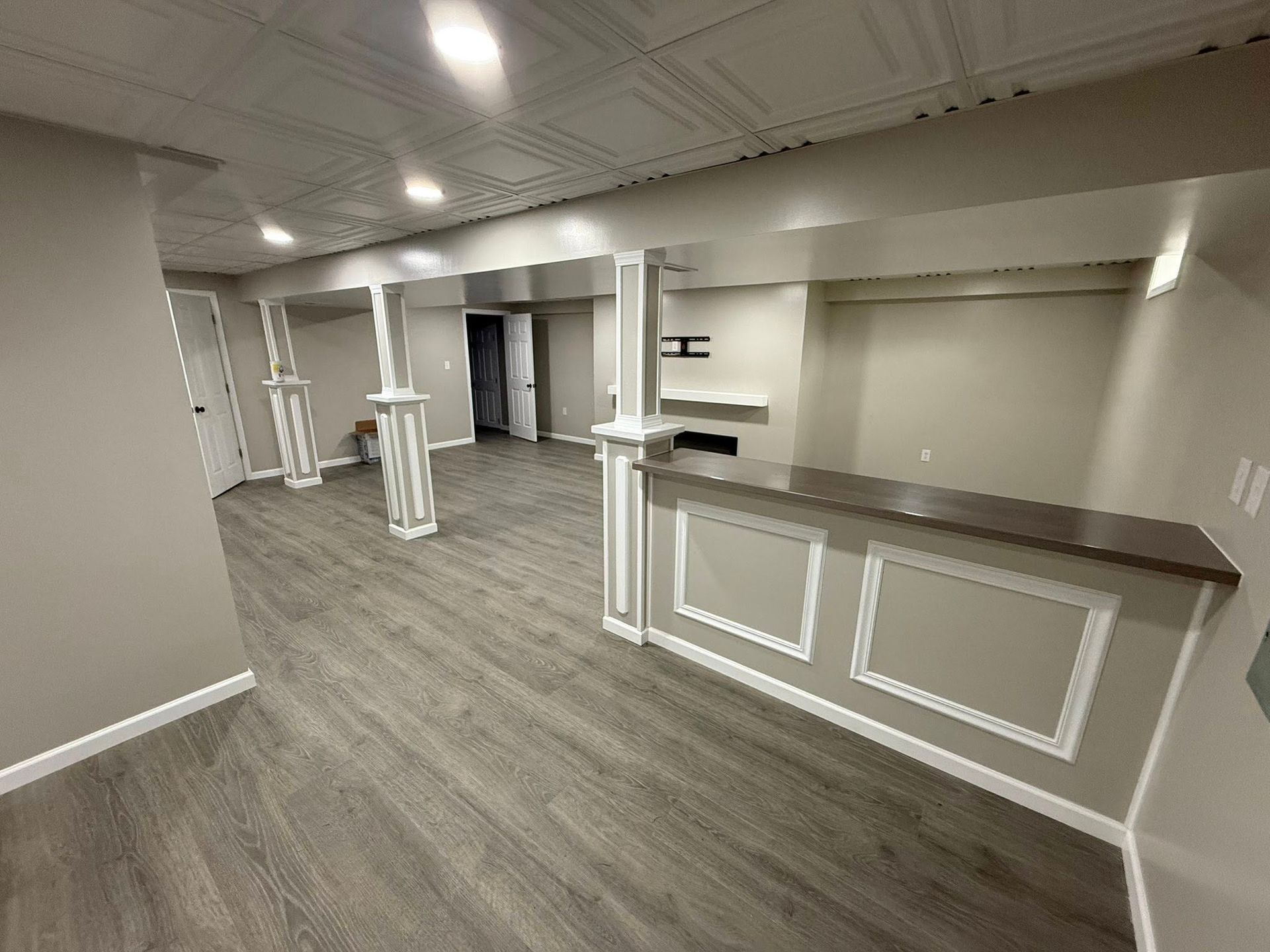 A large room with hardwood floors and a counter in the middle of it.