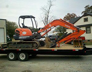 Orange excavator on trailer