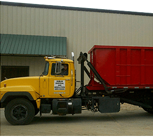 Yellow truck with roll off container