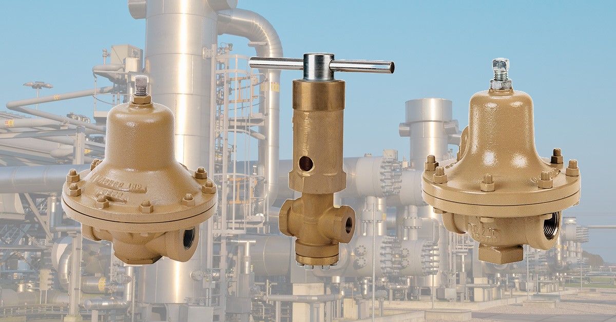 Three bronze pressure relief valves against an industrial background.