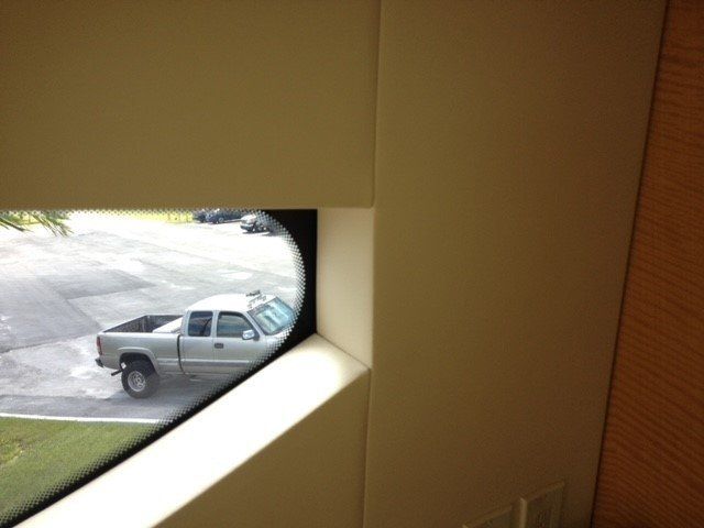 A truck is parked in a parking lot behind a window