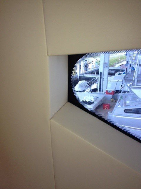 A boat is visible through a window in a room