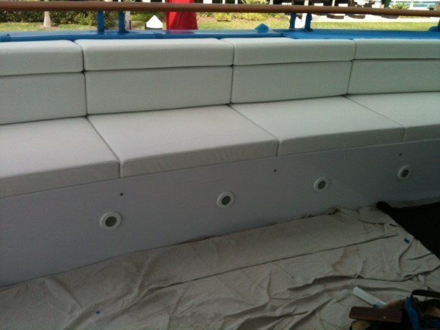 A white couch is sitting on a white cloth