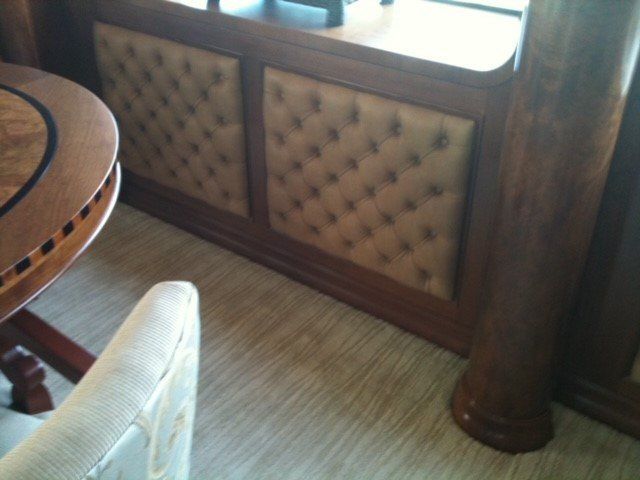 A chair sits next to a wooden table in a room