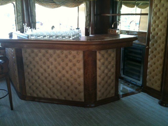 A bar with glasses and bottles on it in a room