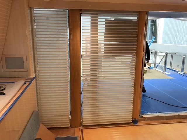 A living room with white furniture and a red box on a table.