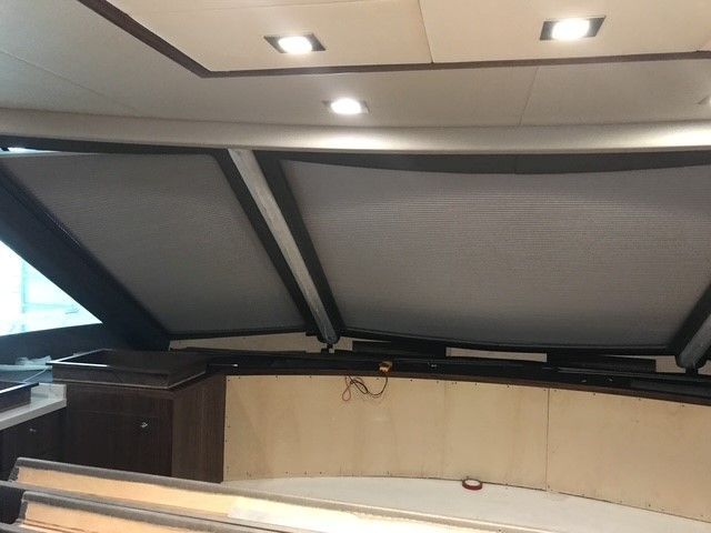 The inside of a boat with the roof open.