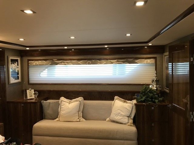 A living room with a couch and a window.