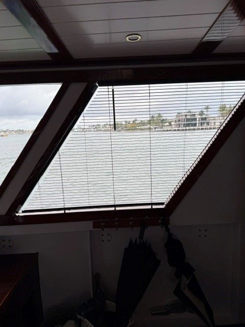 A window on a boat with a view of the water.
