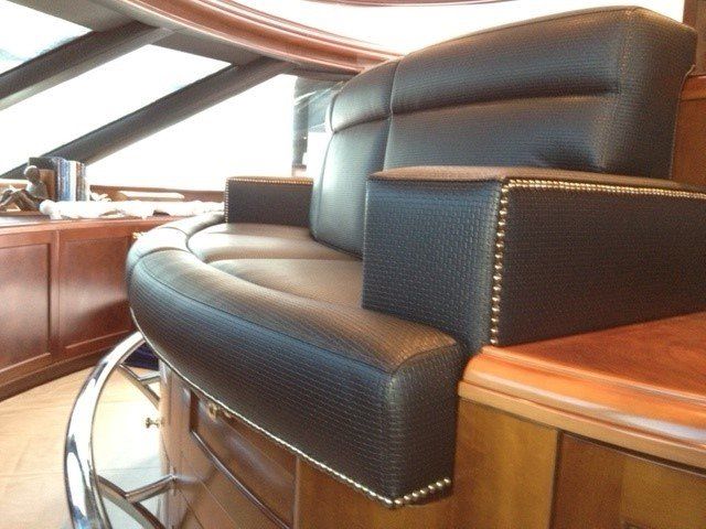 a black leather chair with studs on the arm rests