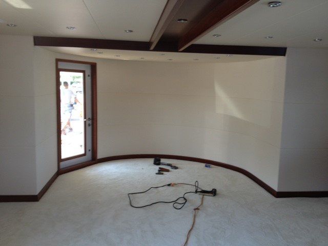 An empty room with white walls and a door