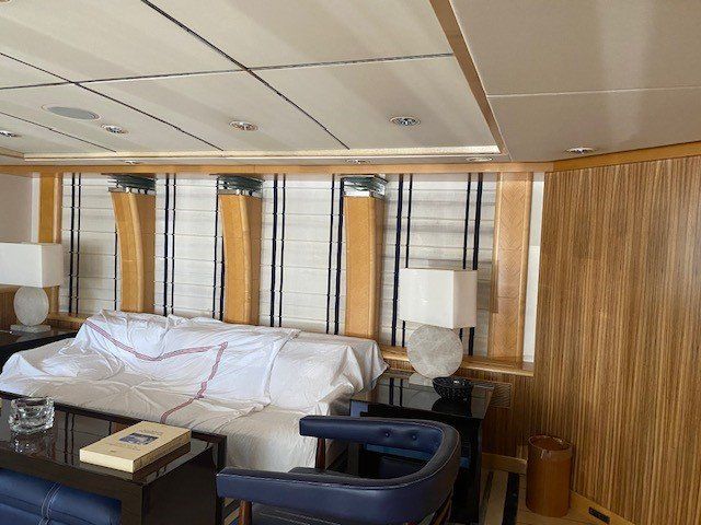 A living room with a couch and chairs and lamps