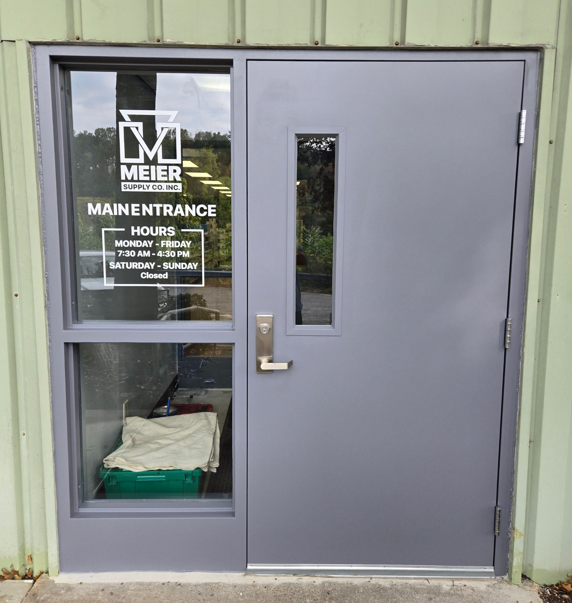 Gray door with a window on the left side and a rectangular window above the handle, 