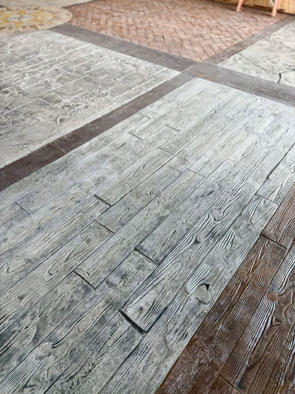 Concrete floor samples with various wood and brick patterns.