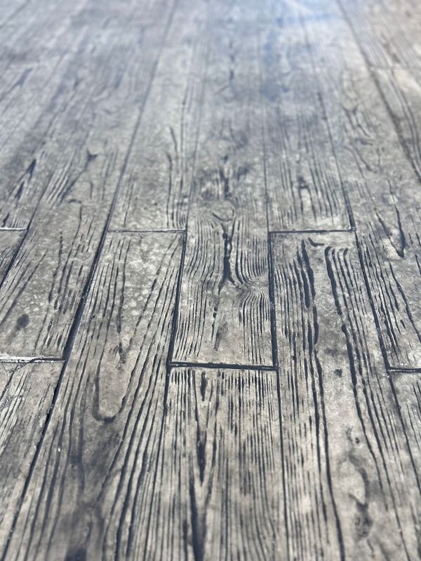 Gray wood-patterned floor with visible grain and rectangular planks.