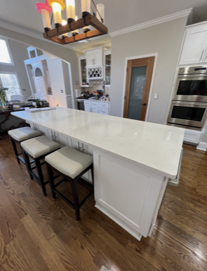White table with chairs and chandelier 