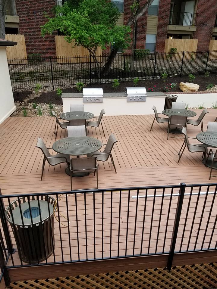 A close up of a wooden fence with trees in the background.
