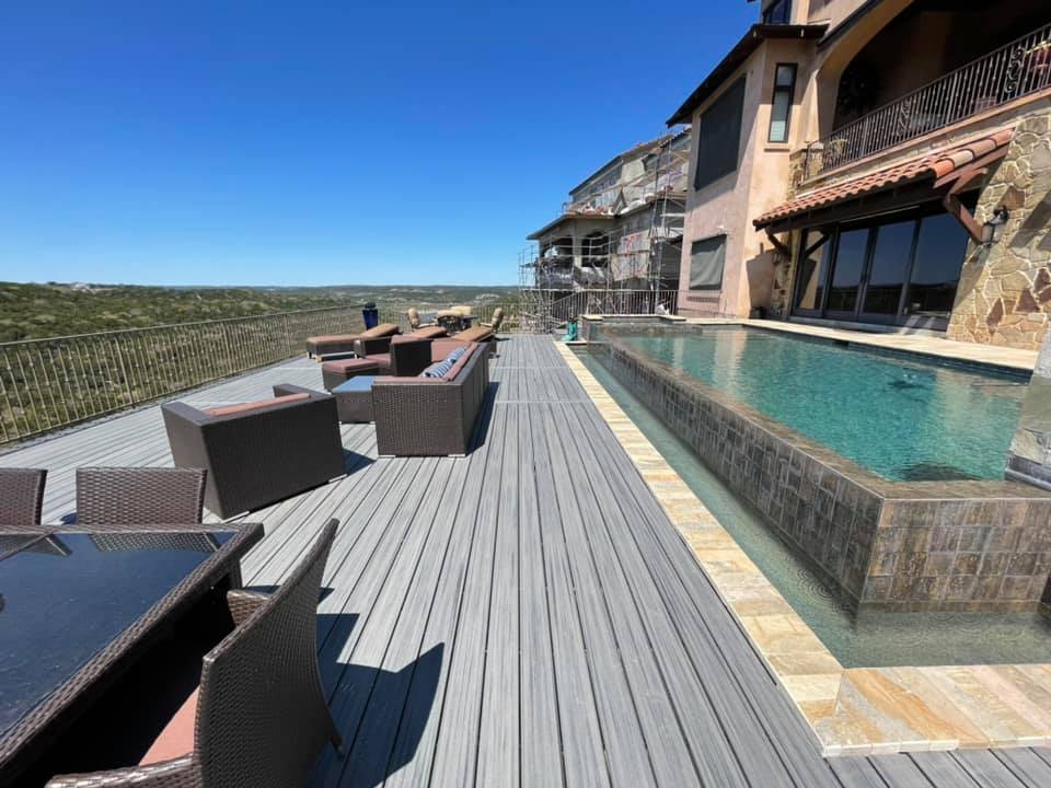 A large house with a large swimming pool in front of it