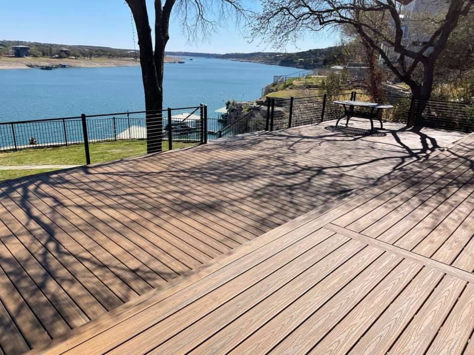 A wooden deck with a view of a lake.