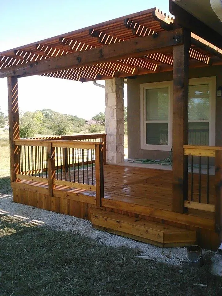 A wooden deck with a pergola over it