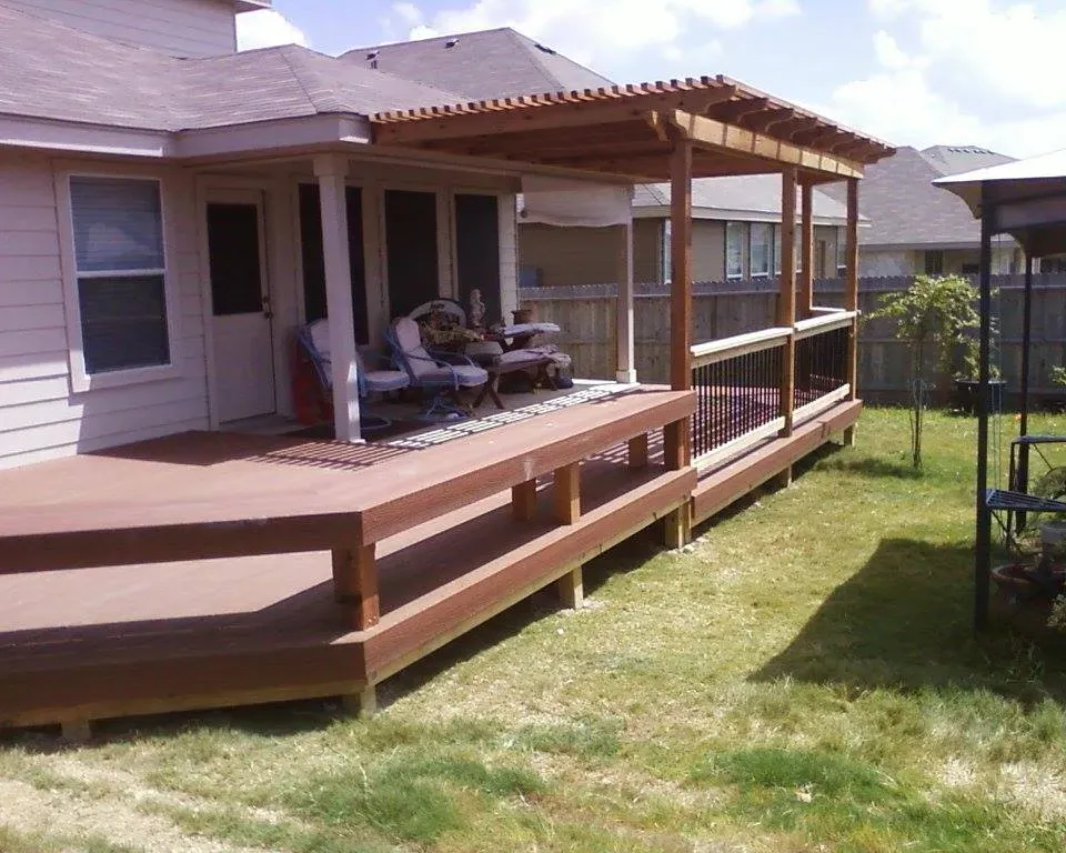 A house with a porch and a trampoline in the backyard