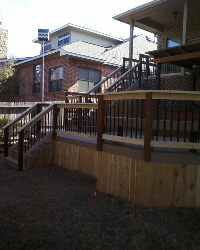 A wooden deck with stairs leading up to it