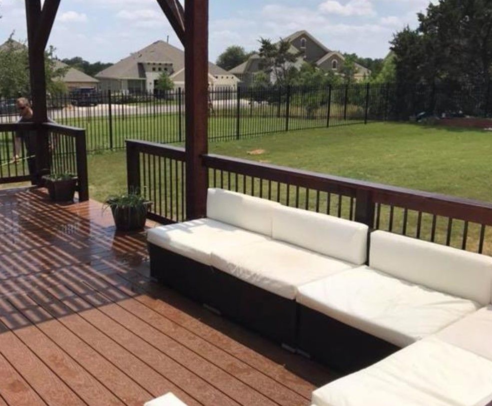 A deck with a couch and a table on it