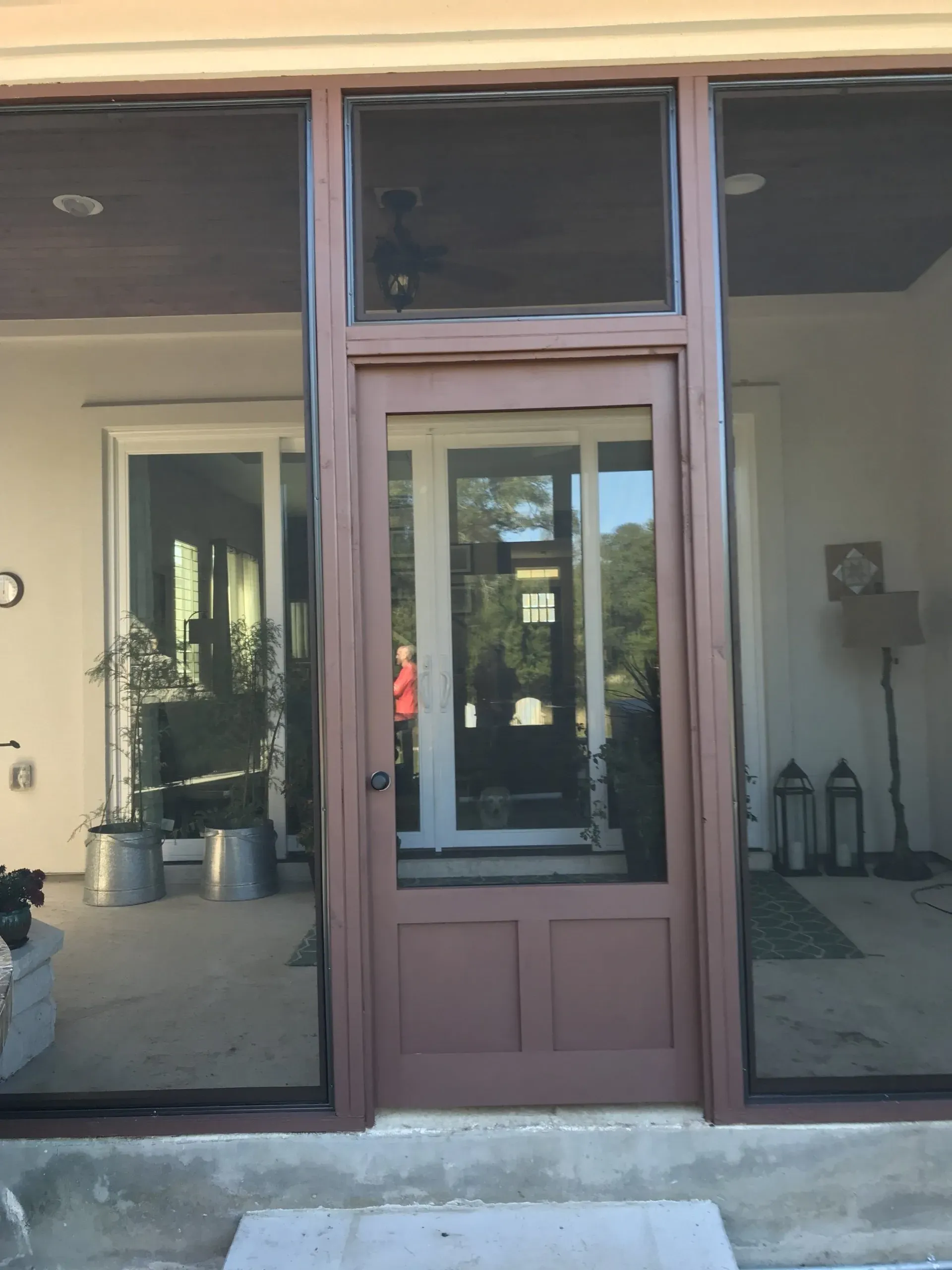 A screened in porch with a brown door