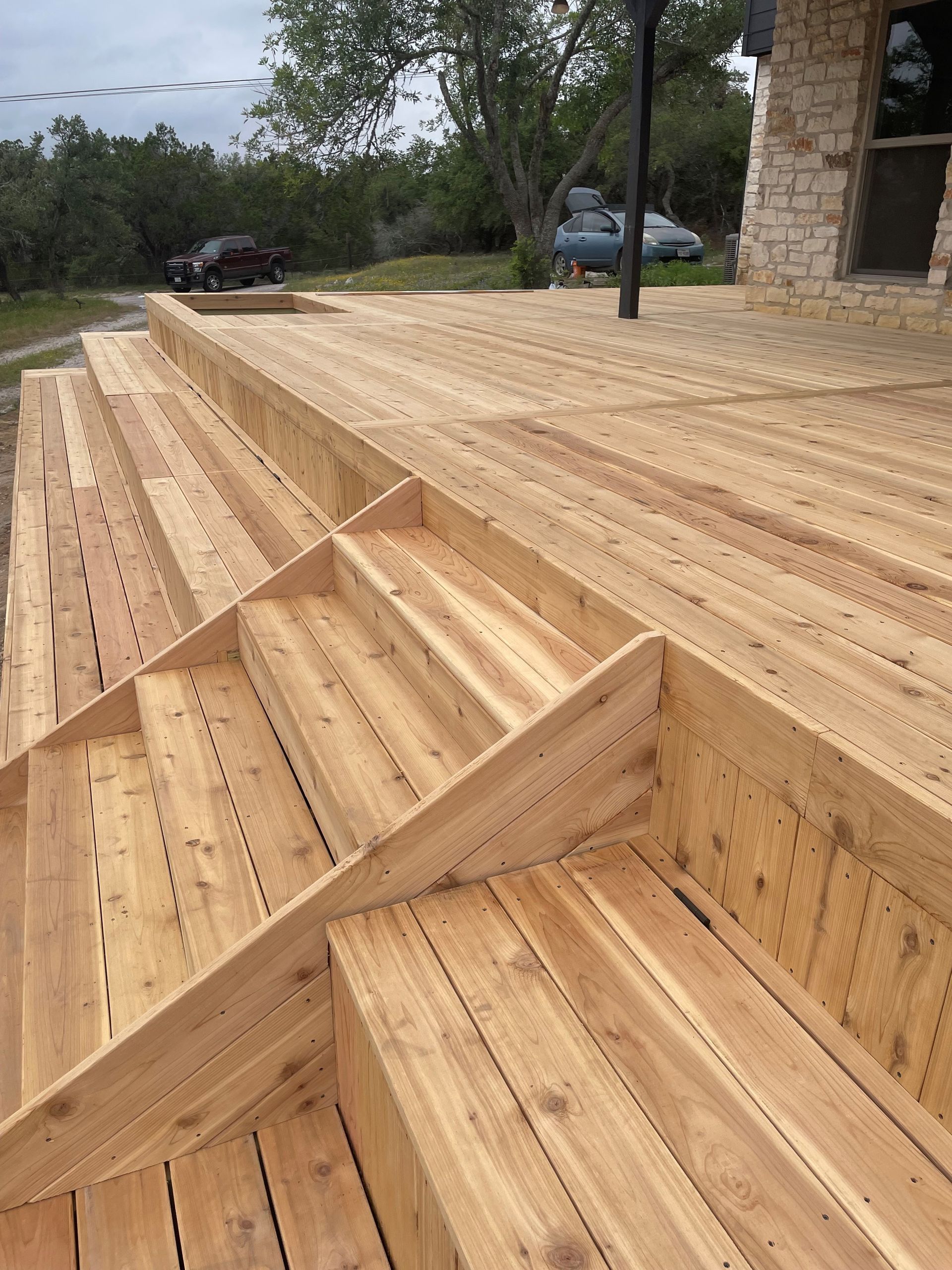 A wooden deck with stairs leading up to it
