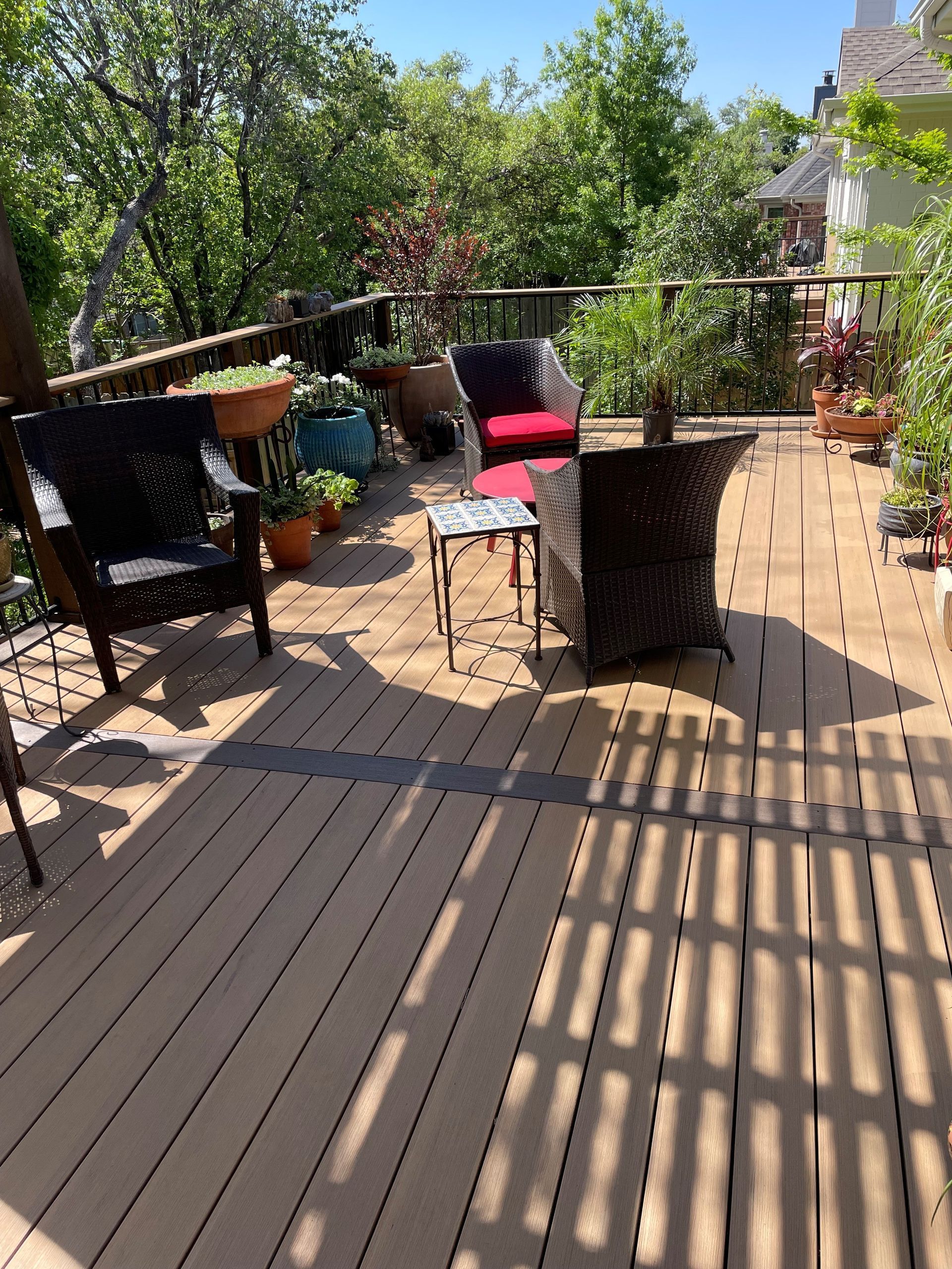 A wooden deck with chairs and a table on it
