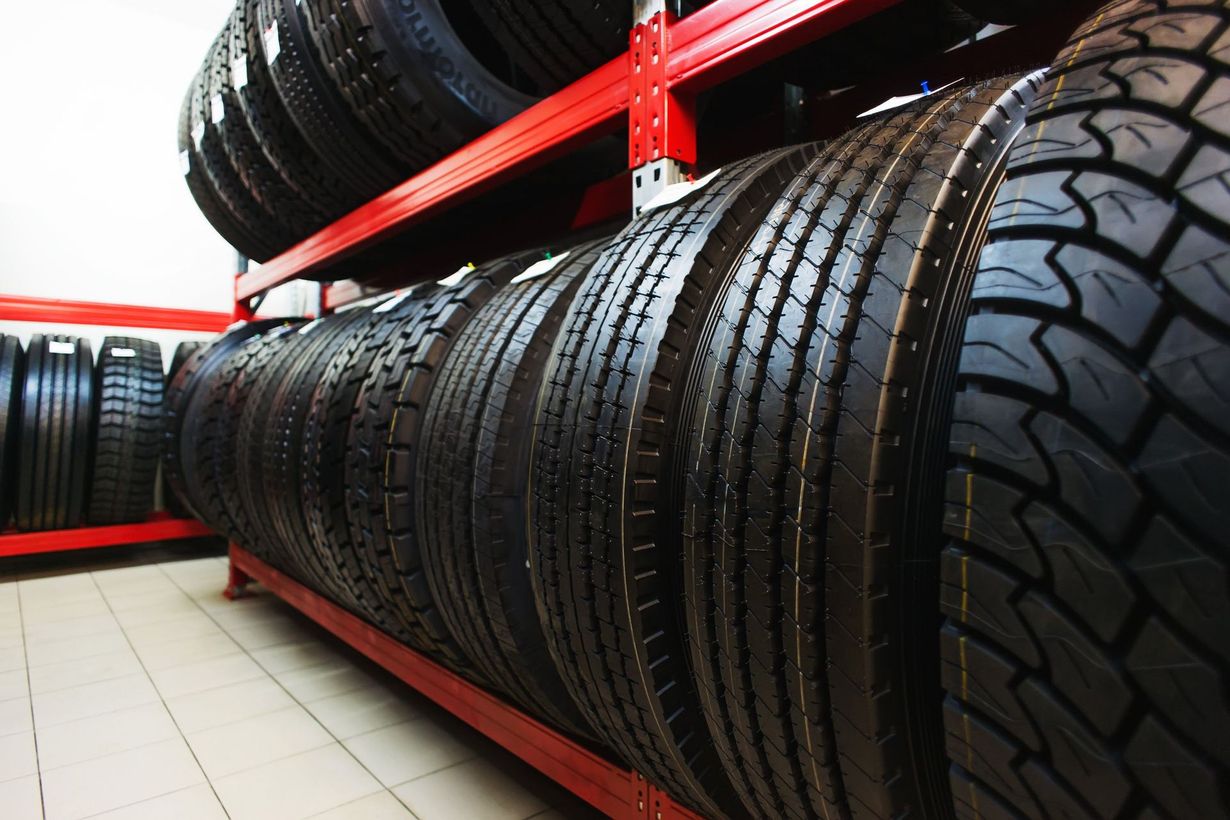 Mechanic inspecting a car wheel in an auto repair shop