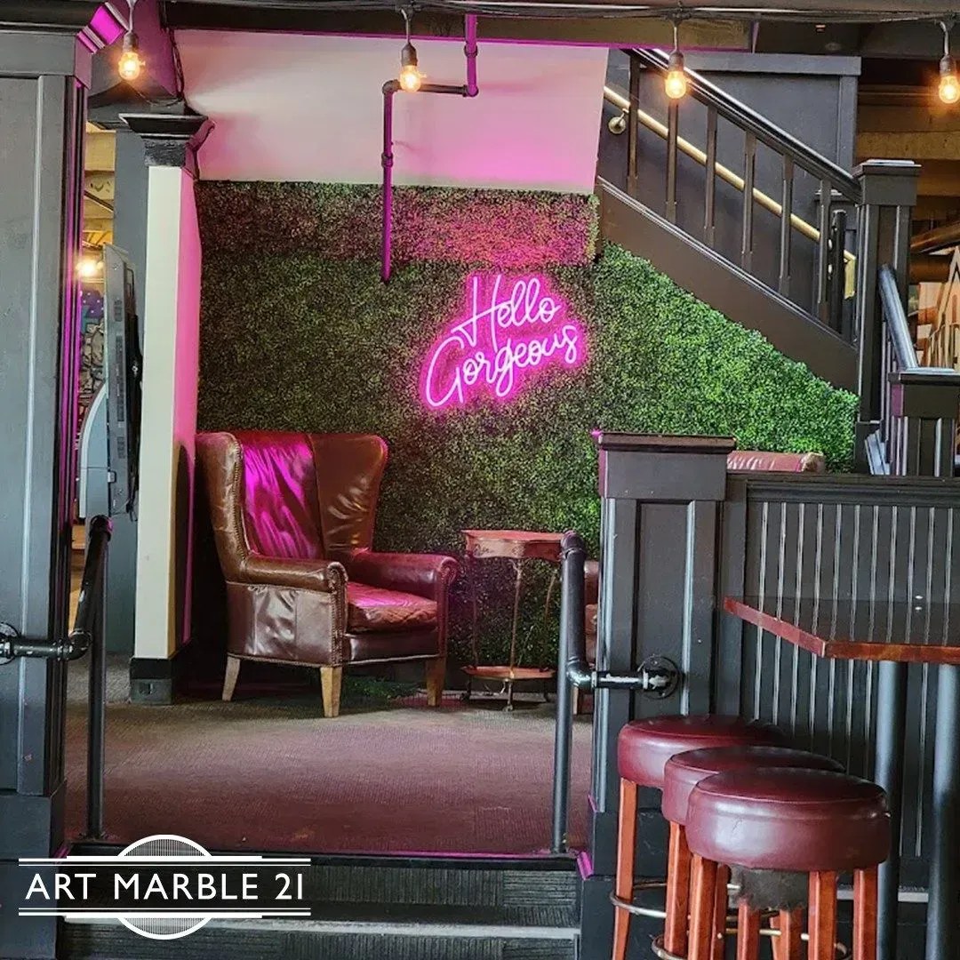 Cozy lounge area with a leather armchair, neon sign