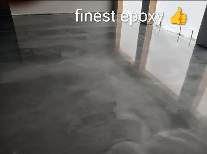 Shiny gray epoxy floor with reflected light and the text “finest epoxy” at top