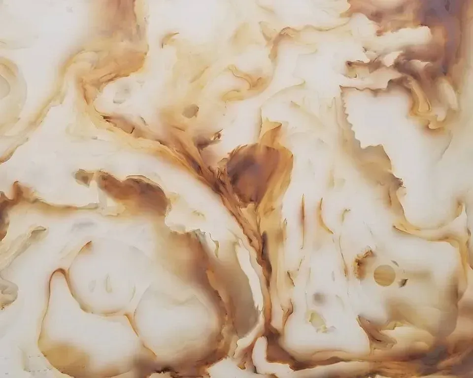 Swirling cream and amber marble pattern.