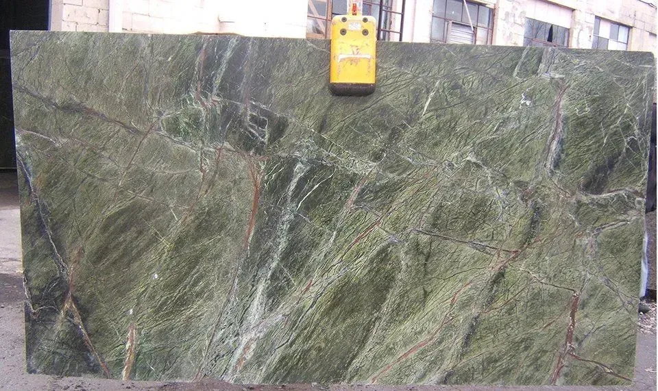 Large green marble slab with white and brown veining, held by a yellow crane.