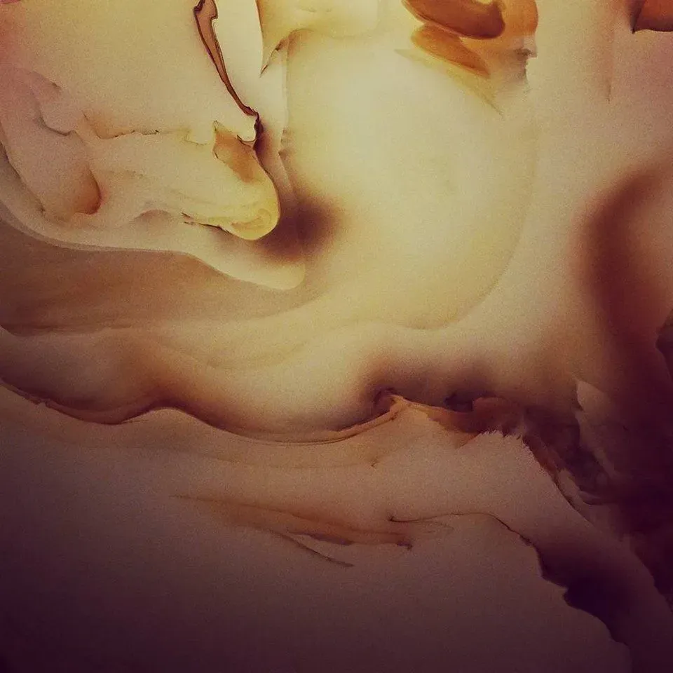 Abstract swirling layers of brown, tan, and yellow, resembling fluid movement or stone textures.